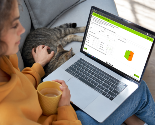 Lady & cat with laptop showing ShipSavy Master Carton Optimizer product live preview