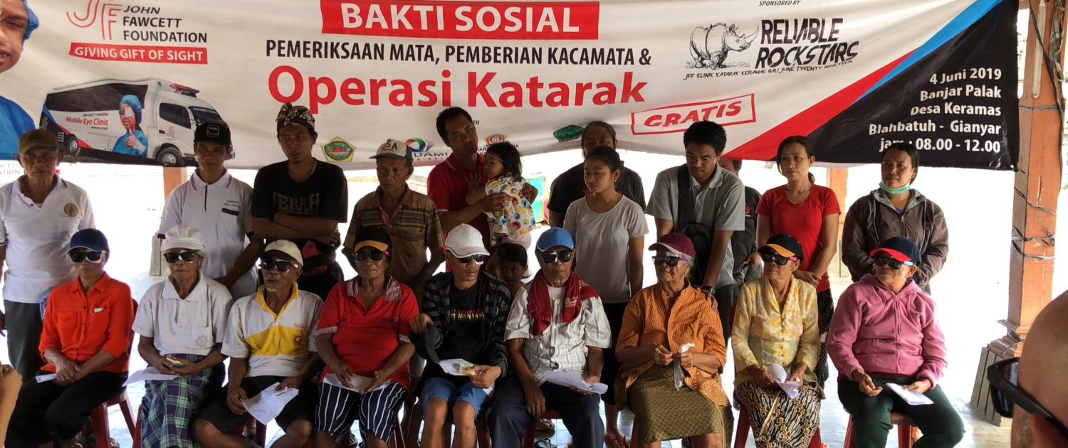 Cataract surgery patients waiting in shade for doctor